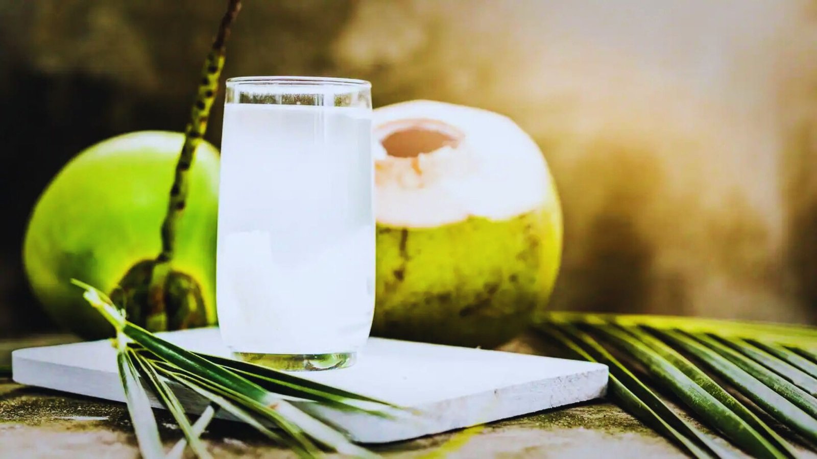 A glass of coconut water on a table, highlighting its refreshing qualities for hydration.